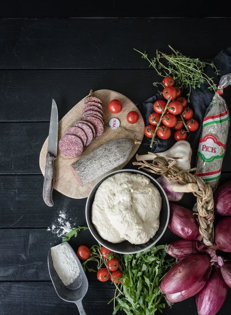 Belag der Pan Pizza mit Salami und Zwiebeln