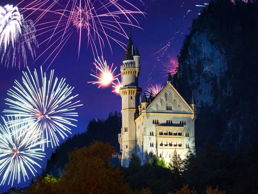 Blick auf Schloss Neuschwanstein in einer Winterlandschaft bei Sonnenuntergang