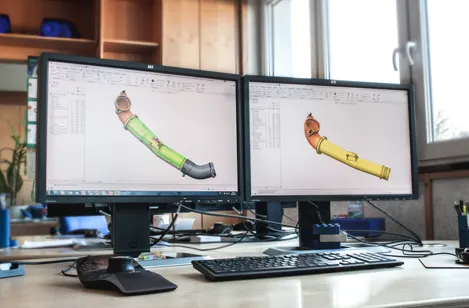 CAD-Arbeitsplätze und Bildschirme, die die Entwicklungskompetenzen von etm engineering technologie marketing gmbh symbolisieren