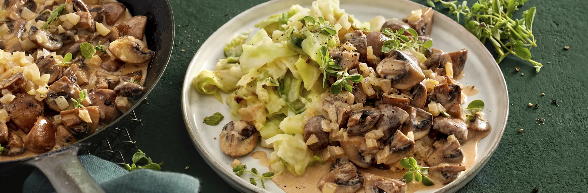 Deftige Pilzpfanne mit cremigem Spitzkohl-Püree, garniert mit Majoran