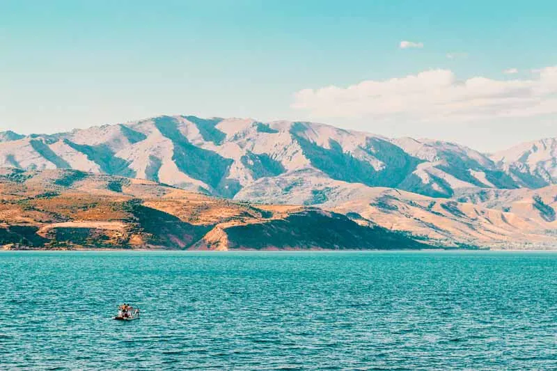 Der Charvak Stausee mit Bergen im Hintergrund in Usbekistan – ein idyllischer Reisetipp für Juli für Naturliebhaber.