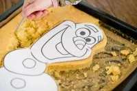 Die ausgeschnittene Olaf-Form auf dem Backblech, bereit für die Weiterverarbeitung und Dekoration als Geburtstagskuchen.