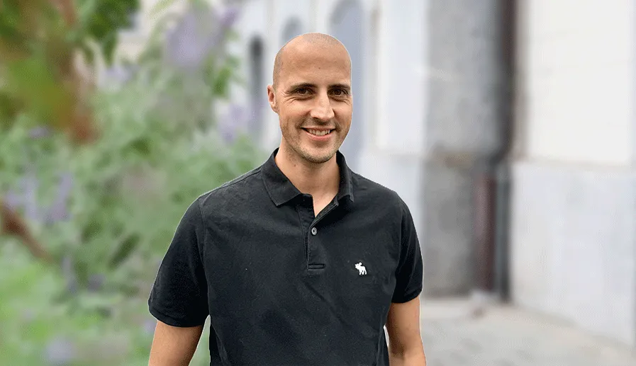 Ein Dozent erklärt etwas an einem Bildschirm, während Teilnehmer zuschauen