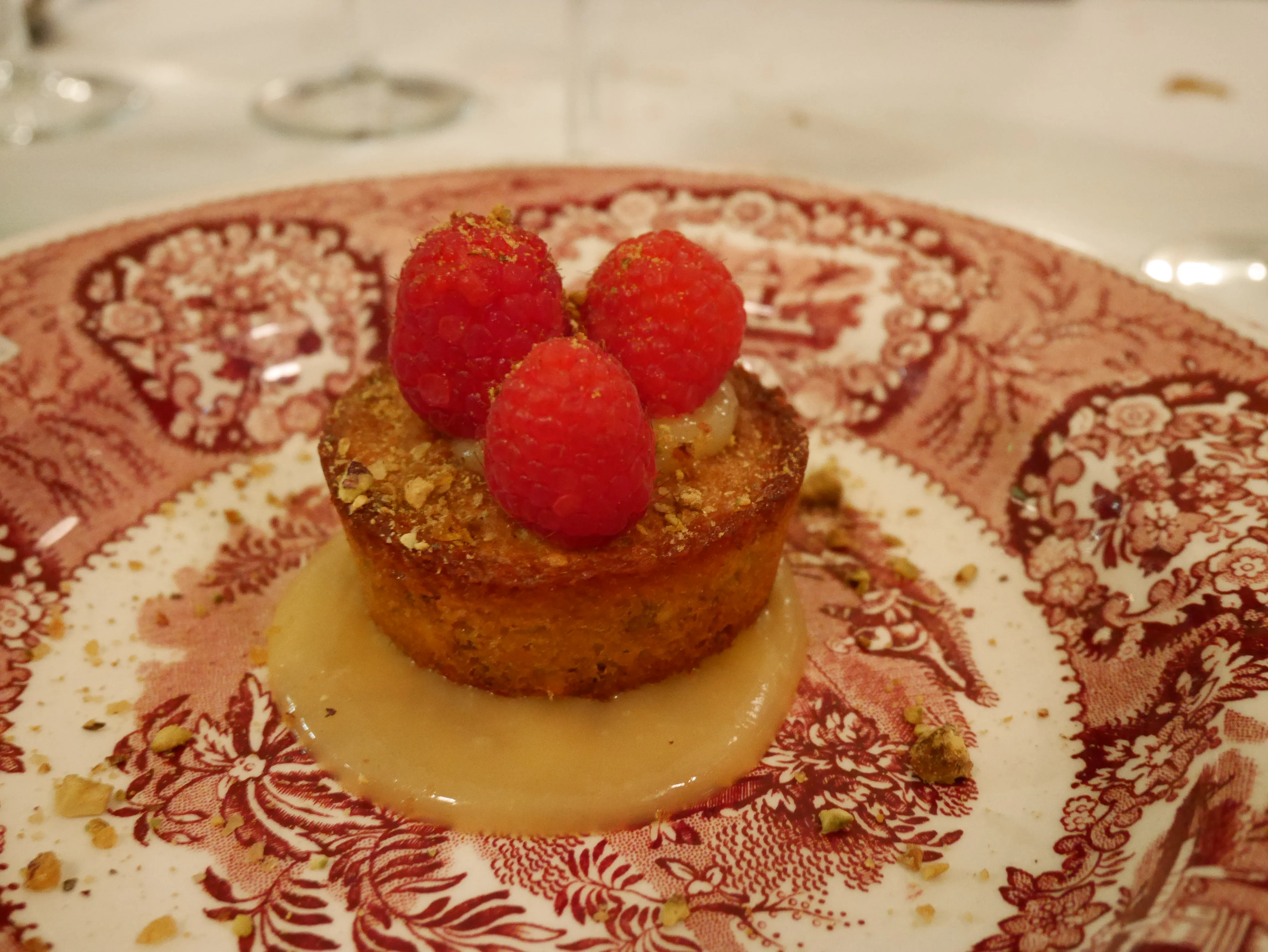 Ein feiner, kleiner Pistazienkuchen mit frischen Himbeeren als süßer Abschluss eines unvergesslichen Essens im Bistrot du Bac.
