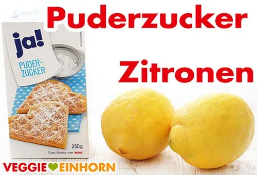 Eine Packung Puderzucker und zwei frische Zitronen auf einer Küchenarbeitsplatte, bereit zur Herstellung eines veganen Zitronenkuchens.