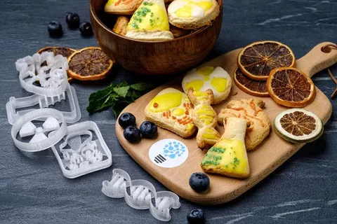 Fertig glasierte Plätzchen mit filigranem Zuckerguss, die die Kunst des Plätzchen Dekorierens zeigen.