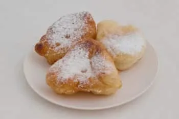 Frittierte Mekitsa, ein bulgarisches Fladenbrot, bestreut mit Puderzucker – eine beliebte Balkan Backware.