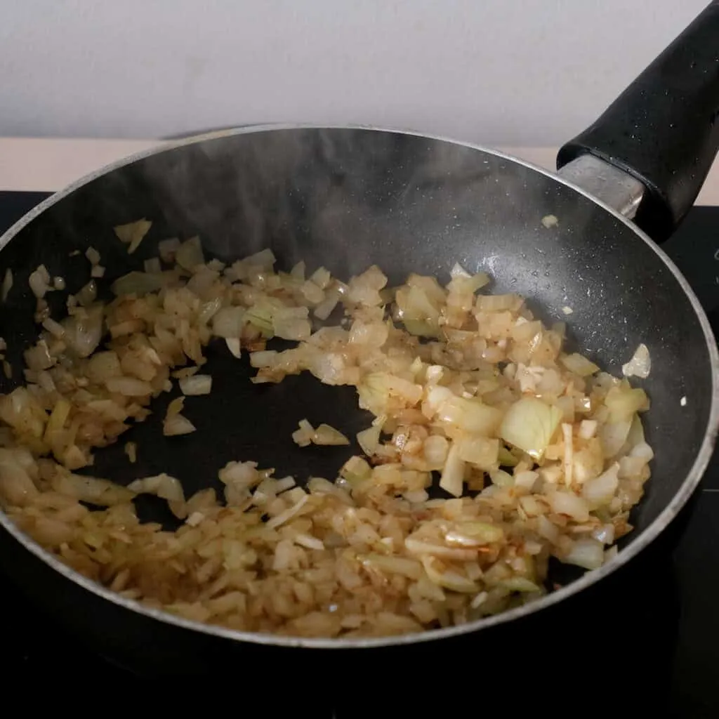 frying onions for spinach dumplings.