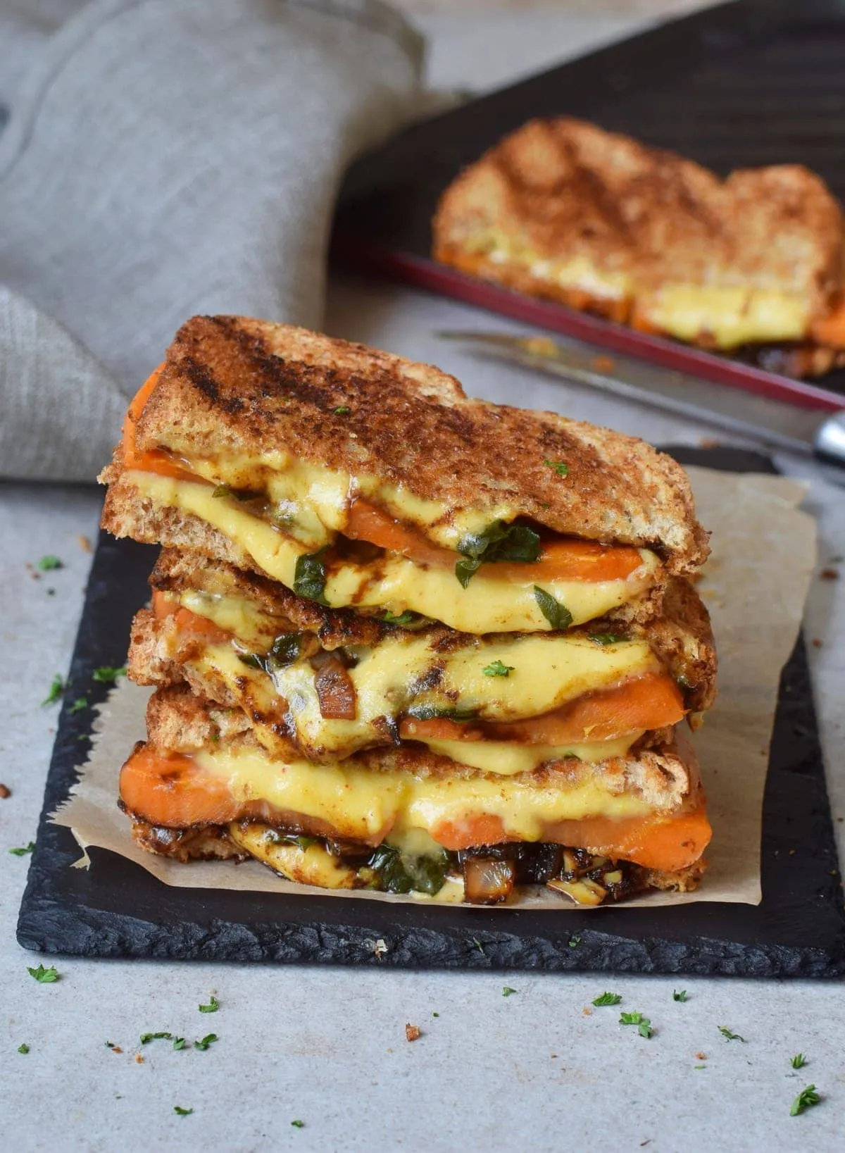 Gemütliches veganes gegrilltes Käsesandwich mit Gemüse und veganer Käsesauce, ideal für ein wohliges Mittagessen.