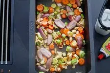 Geröstetes Suppengemüse mit Tomatenmark und Zucker im Bräter