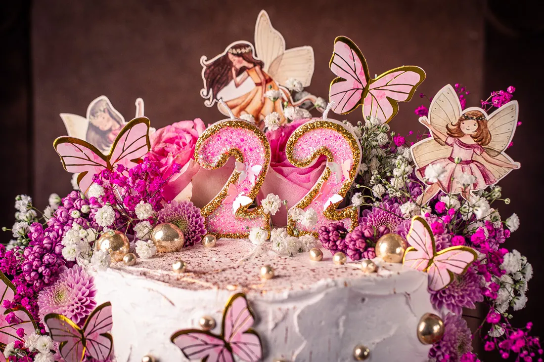 Glitzernde Geburtstagskerzen und Feenstaub auf dem Feen Geburtstagskuchen