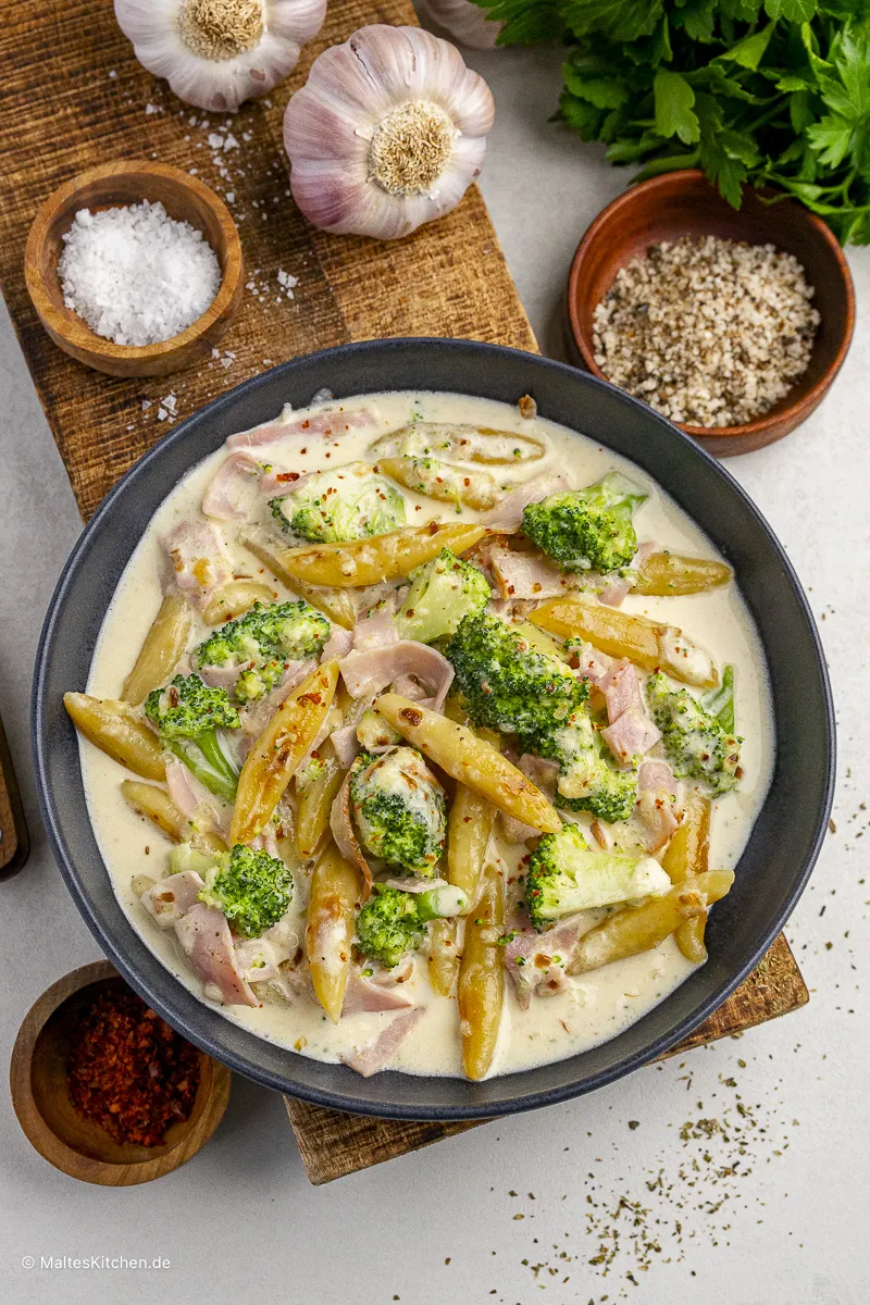 Herzhaftes Schupfnudel-Gericht mit Kochschinken, frischem Brokkoli und cremiger Käsesauce in einer Pfanne