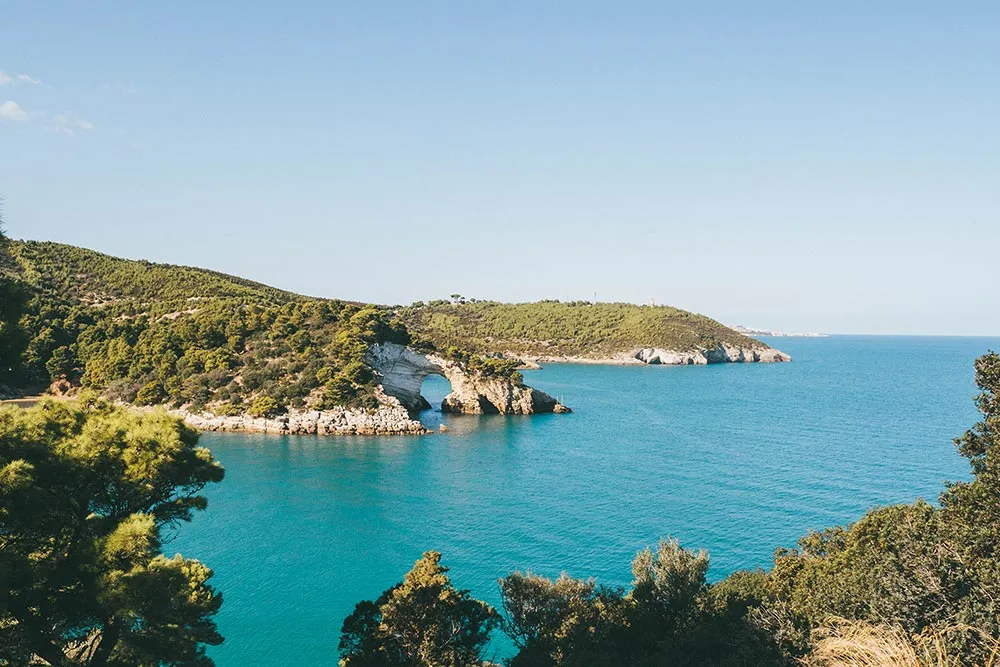 Idyllischer Strandabschnitt in Apulien mit Felsen und azurblauem Meer