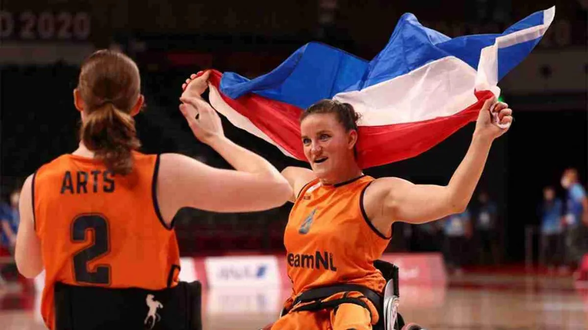 Jiske Visser bei einem Rollstuhlbasketballspiel, umgeben von Teamkolleginnen, mit Fokus auf Aktion und Entschlossenheit.