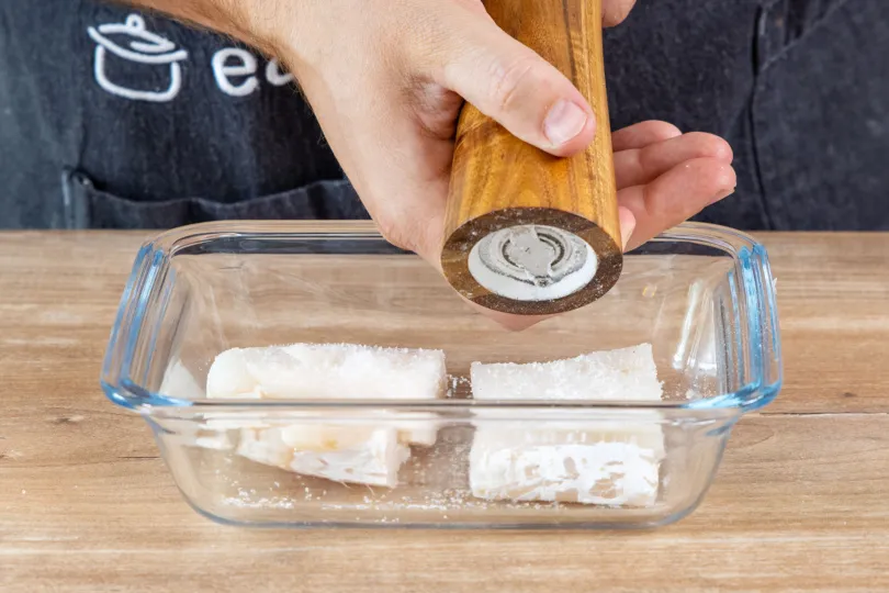 Kabeljaufilet beidseitig salzen, pfeffern und gleichmäßig in Mehl wenden für eine knusprige Hülle beim Braten.