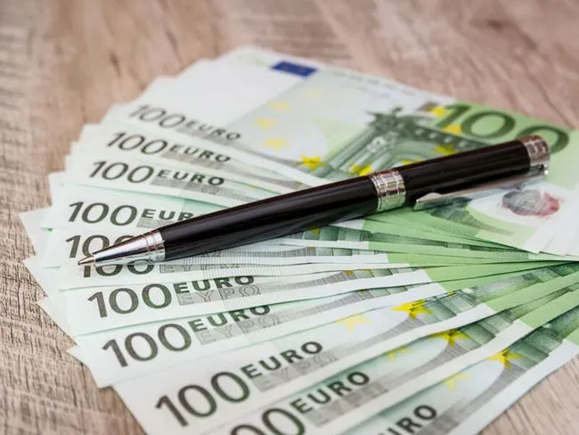 Lebensversicherung verkaufen: Stift auf Geldscheinen