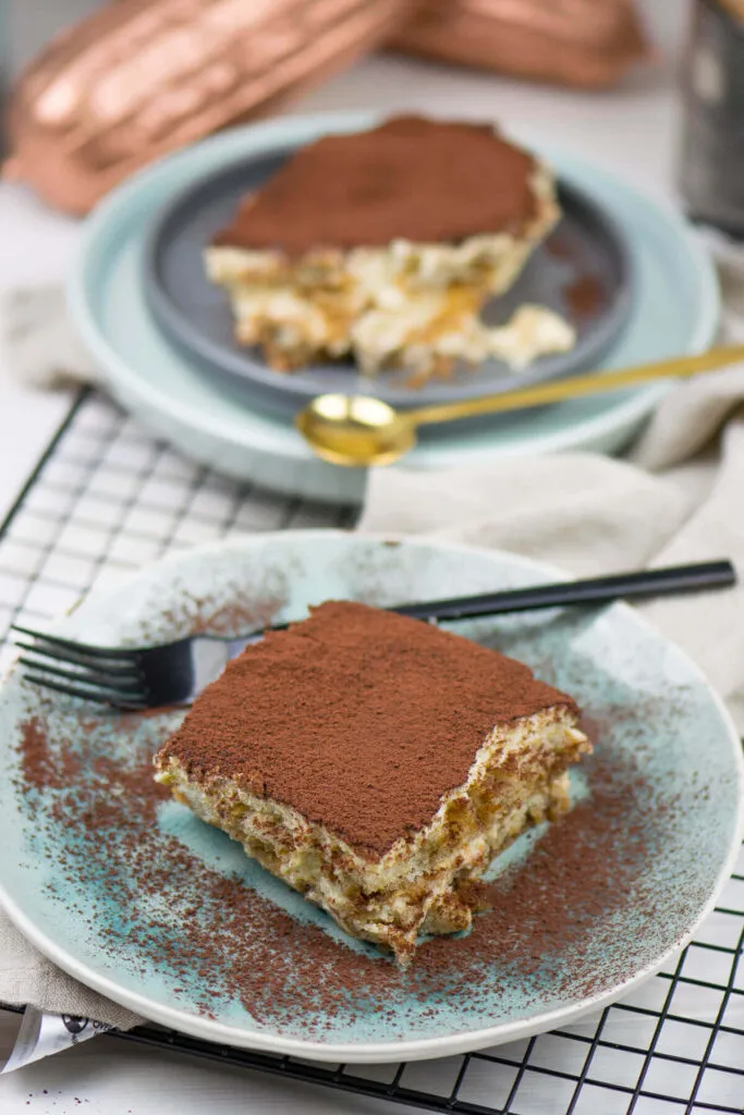 Nahaufnahme einer Portion alkoholfreies Tiramisu mit Löffel, die die cremige Textur und die einzelnen Schichten des Desserts zeigt, ideal für Tiramisu für Schwangere oder Tiramisu für Kinder.