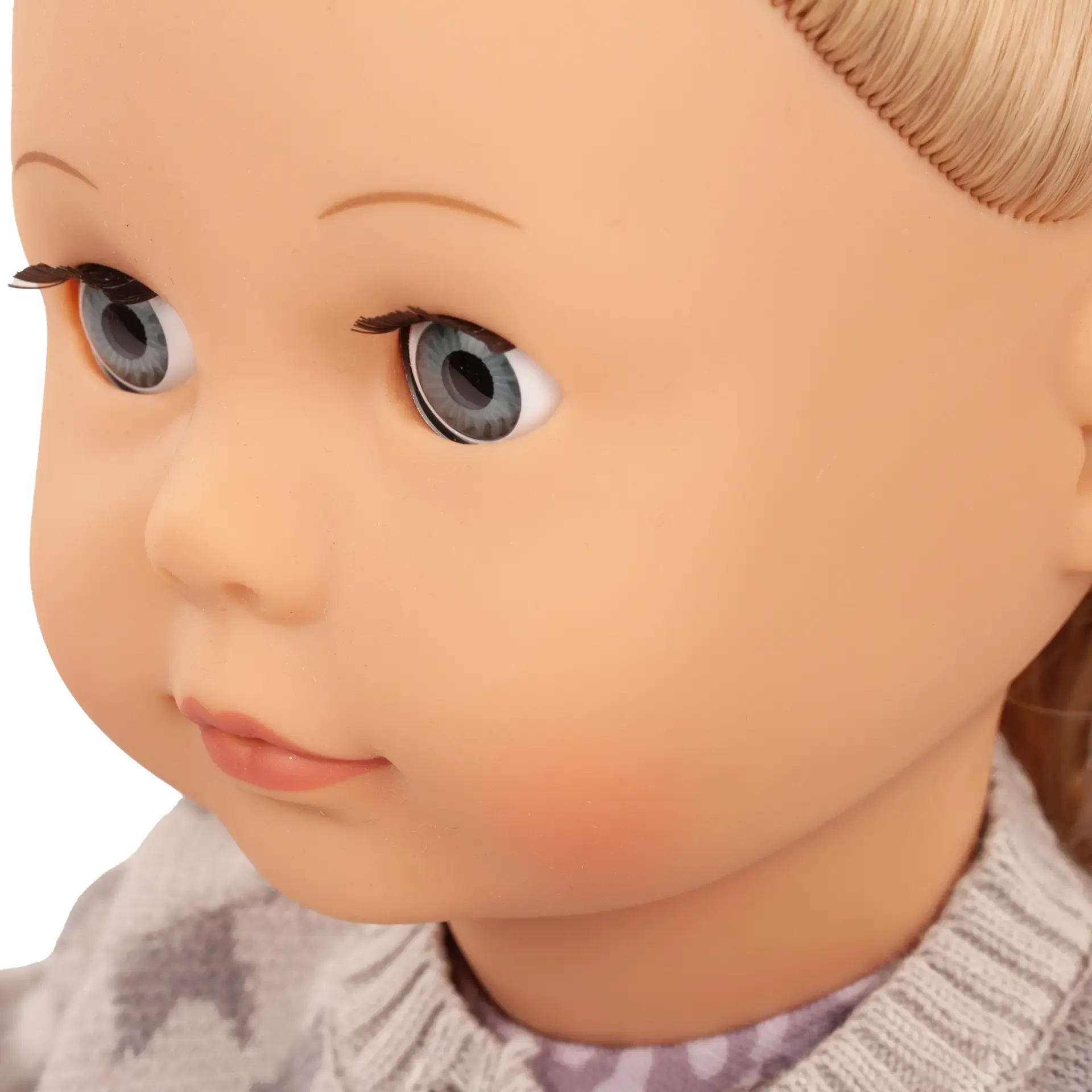 Porträt einer Puppe mit blauen Schlafaugen und blondem Haar.