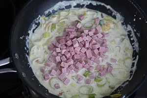 Schritt 6: Schinkenwürfel in die Soße geben.