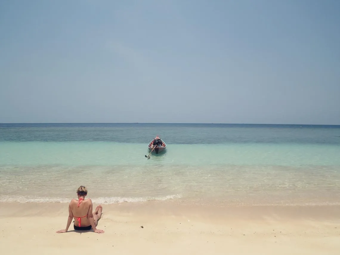 Tropischer Strand in Thailand mit Palmen und türkisblauem Meer, ideal für warme Winterreiseziele