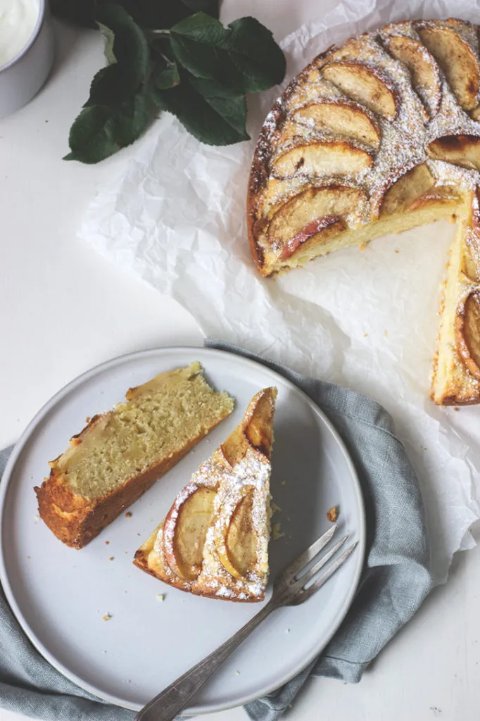 Ungeschnittener schwedischer Apfelkuchen mit Apfelspalten und Zimt auf saftigem Rührteig, bereit zum Backen.