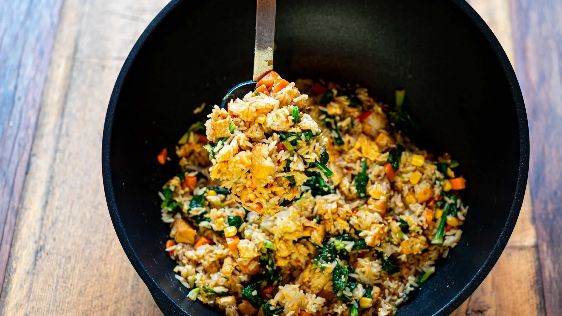 Vegetarischer gebratener Reis mit mariniertem Tofu, frischem Gemüse und Sojasauce, ein schnelles chinesisches Gericht