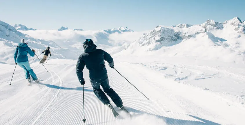 Winterlandschaft mit Skifahrern in einer alpinen Region
