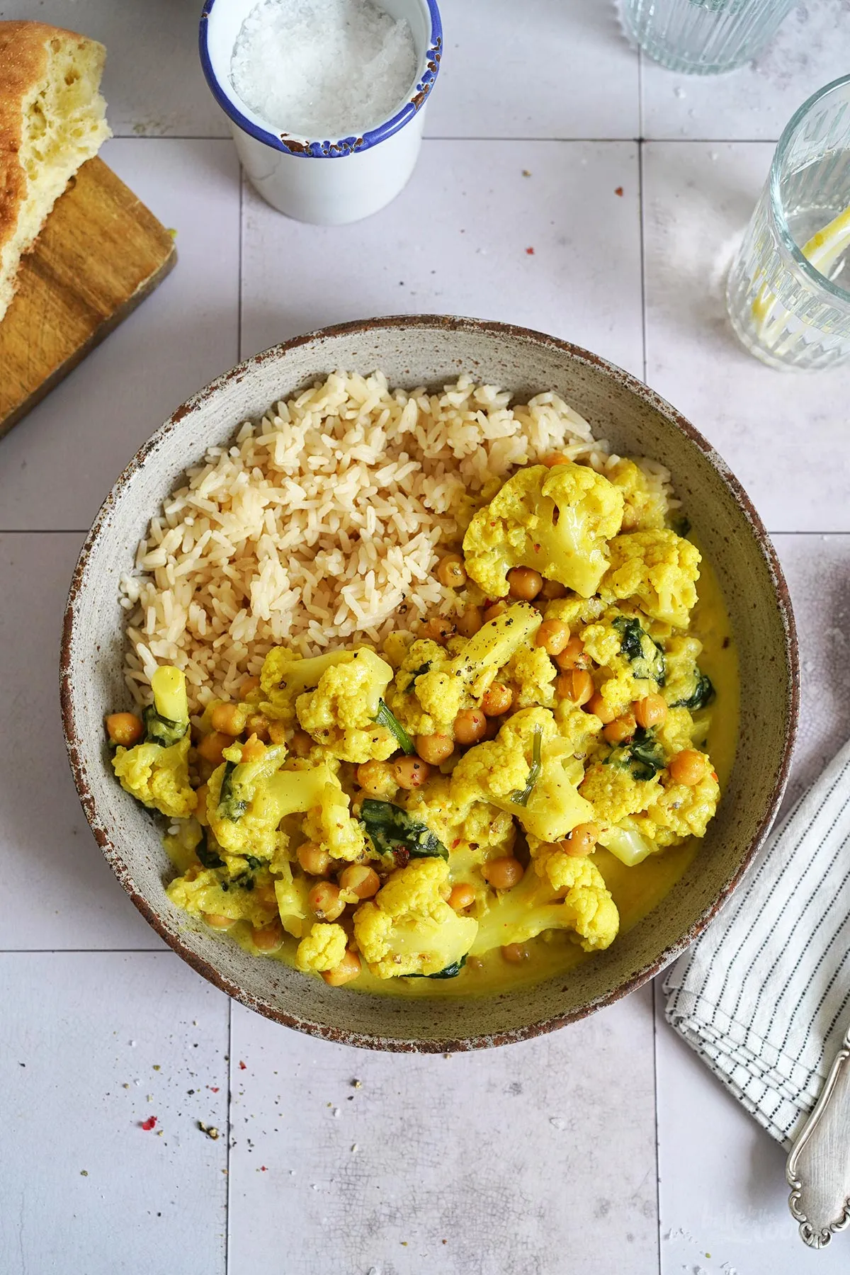 Zutaten für ein veganes Kichererbsen Curry: frischer Blumenkohl, Gewürze und Kokosmilch