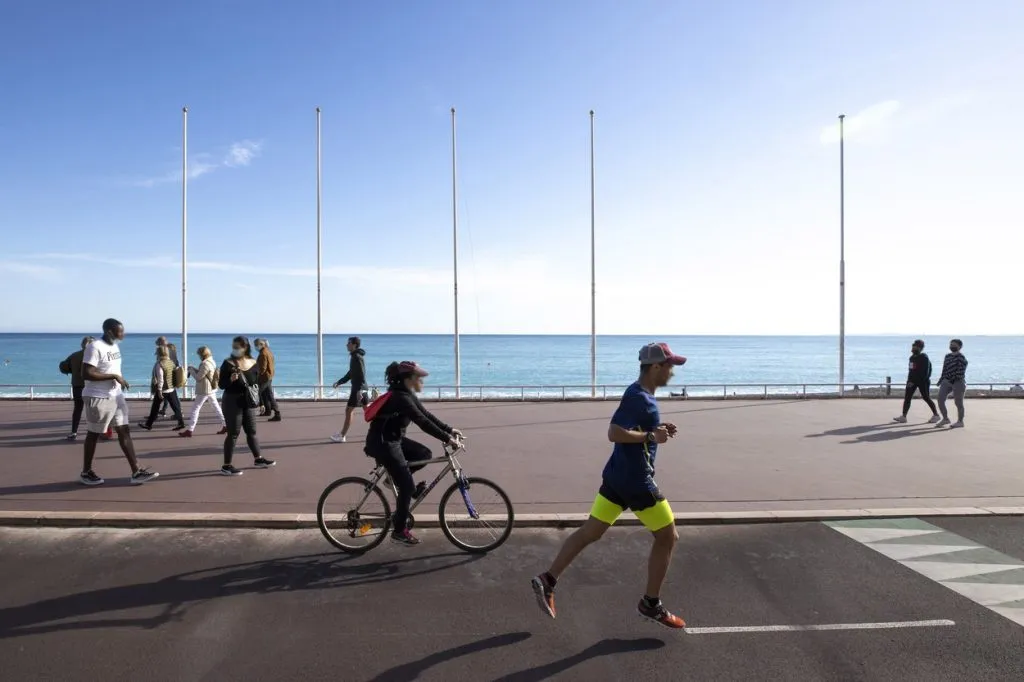 Zwei Athleten beim Fahrradfahren und Joggen nebeneinander auf einem Weg, symbolisieren den Vergleich beider Ausdauersportarten
