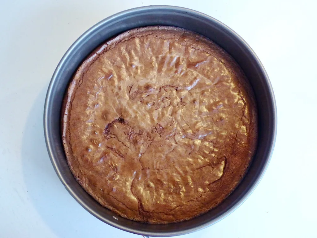 Der vorbereitete Schokoladenteig wird in eine runde Kuchenform gegossen, bereit zum Backen