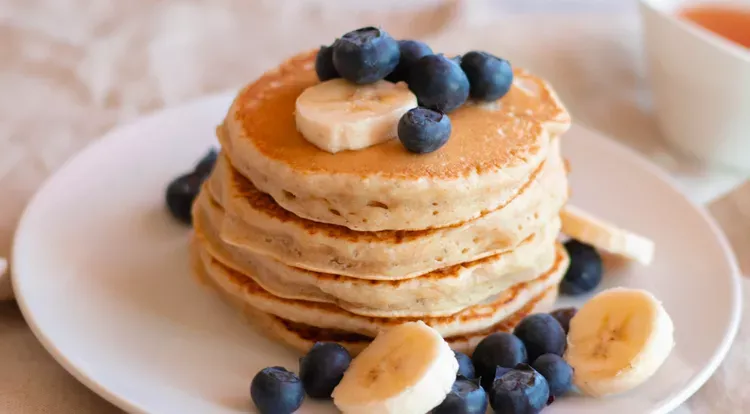 Drei perfekt gebratene, fluffige Protein-Pancakes, übereinander gestapelt und leicht gebräunt.