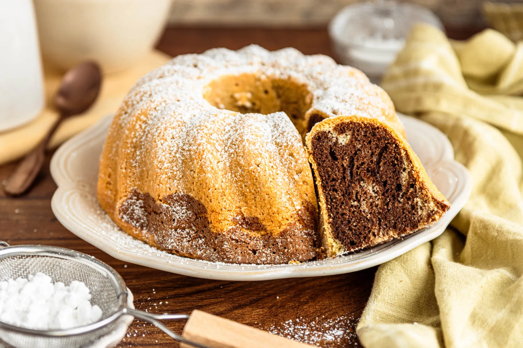 Ein frisch gebackener Marmorkuchen ohne Butter, perfekt aus der Form gestürzt und leicht mit Puderzucker bestäubt