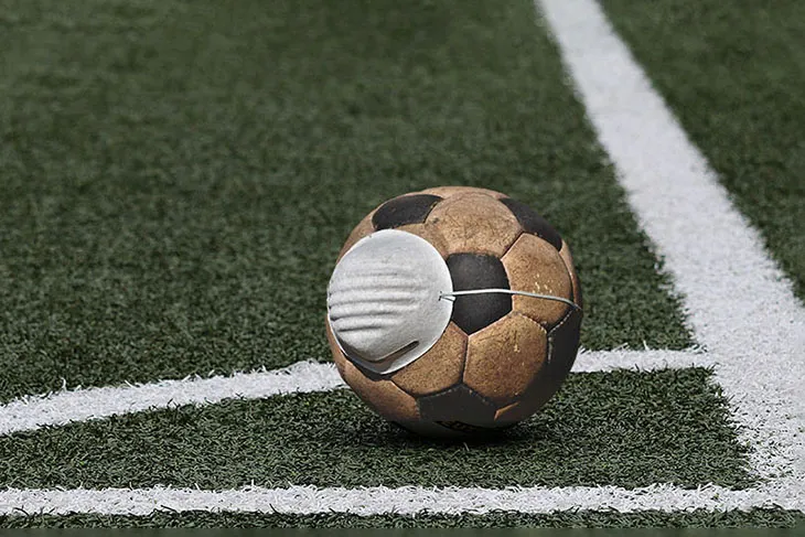 Ein Fußball mit Gesichtsmaske, der die Vorsicht im Amateurfußball während der Pandemie symbolisiert