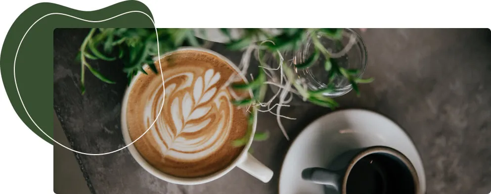 Ein Kaffeevollautomat, der eine Tasse dampfenden Latte Macchiato zubereitet, mit frischen Kaffeebohnen und Milchschaum.