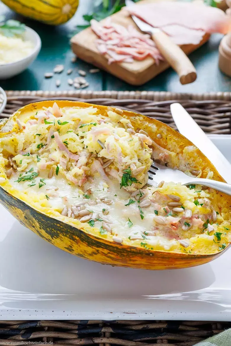 Ein servierter Spaghettikürbis, gefüllt mit herzhaften Zutaten und goldbraun überbacken