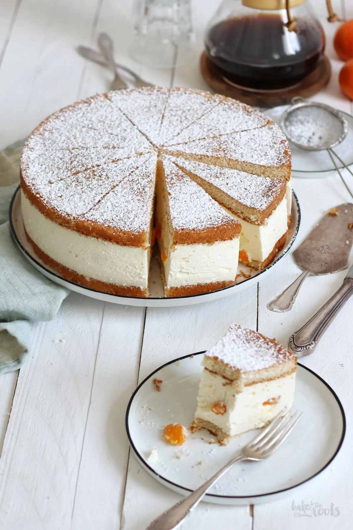 Eine fertig zubereitete Orangen Quark Sahne Torte auf einem Tortenständer, bereit zum Genießen