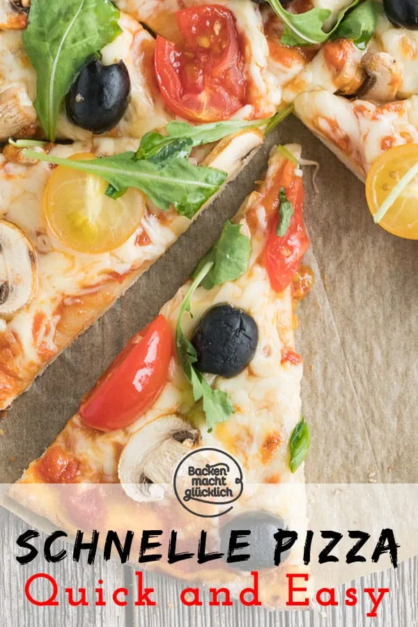 Eine frisch belegte Pizza vor dem Backen, mit verschiedenen Gemüsesorten und Käse