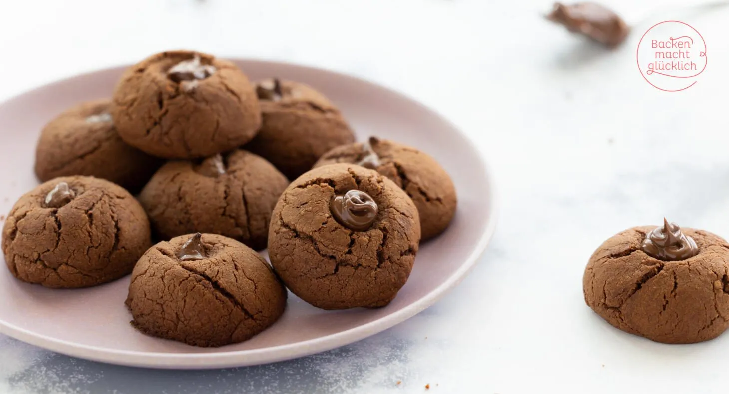 Fertige Nutella Kekse mit Puderzucker bestreut, servierfertig auf einem Teller