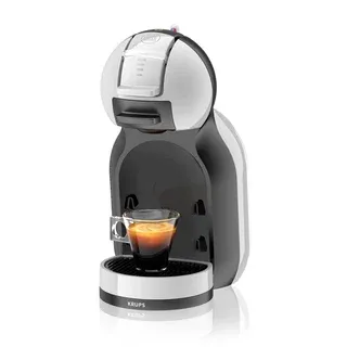 Kompakte Dolce Gusto Kaffeemaschine mit bunten Kapseln.