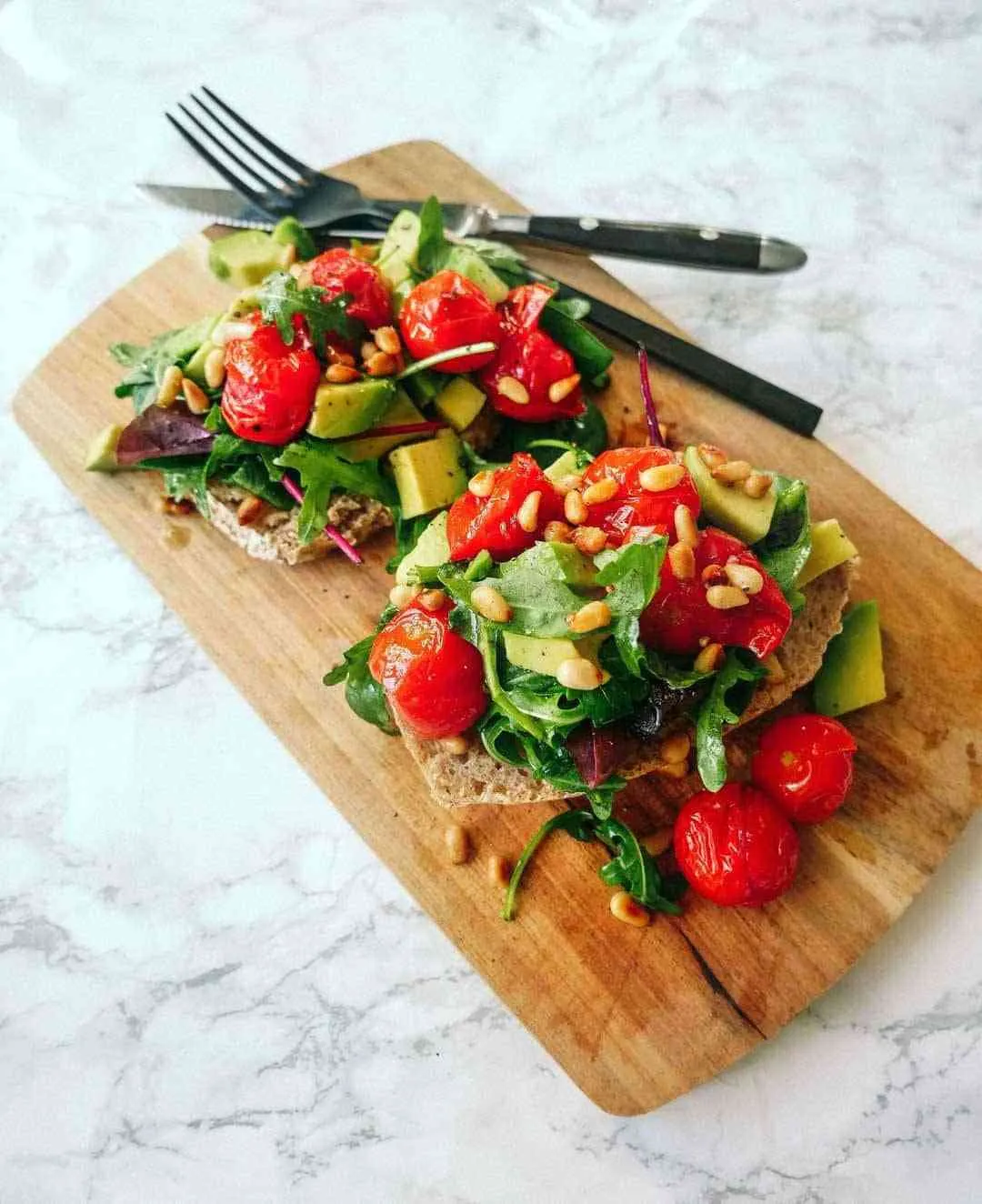 Rucola Salat auf gebackenem Sauerteigtoast angerichtet
