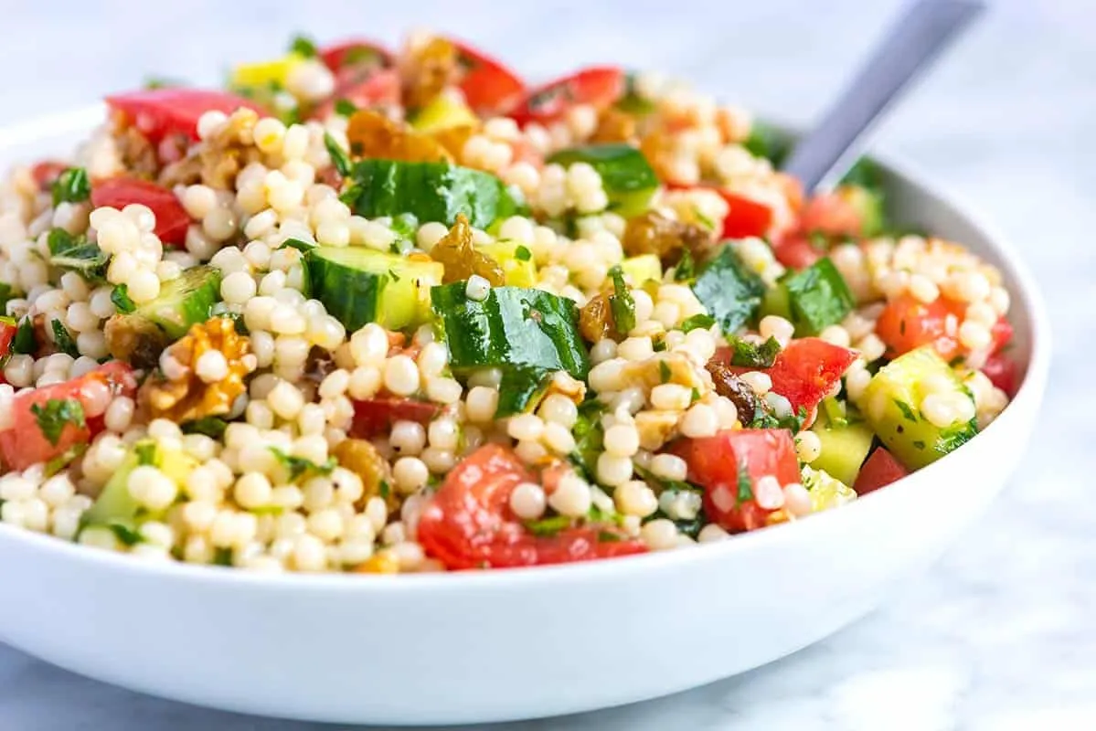 Sommerlicher Couscous Salat in einer Glasschale angerichtet
