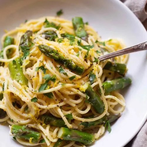 Zitronen-Parmesan-Pasta mit grünem Spargel in Nahaufnahme
