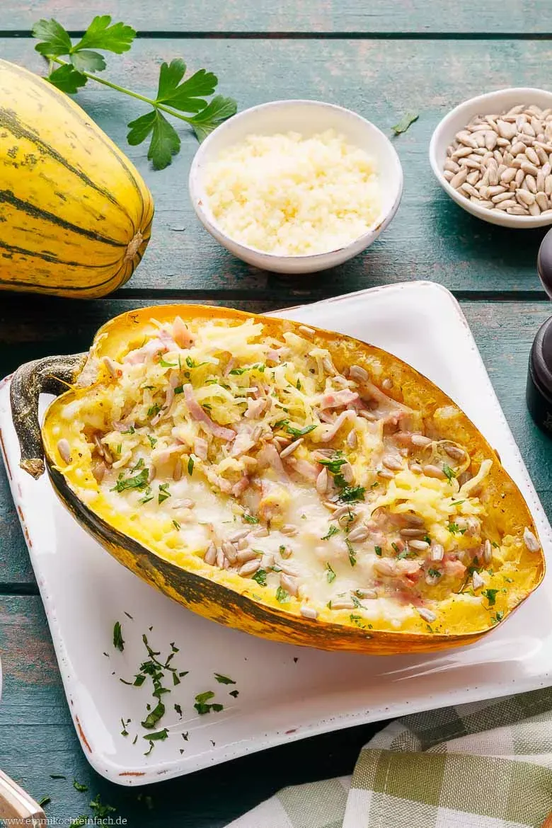 Zwei halbierte Spaghettikürbisse auf einem Backblech, bereit zum Backen