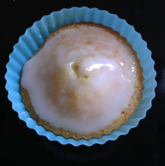 Den Muffin-Rohling mit Zuckerguss bestreichen