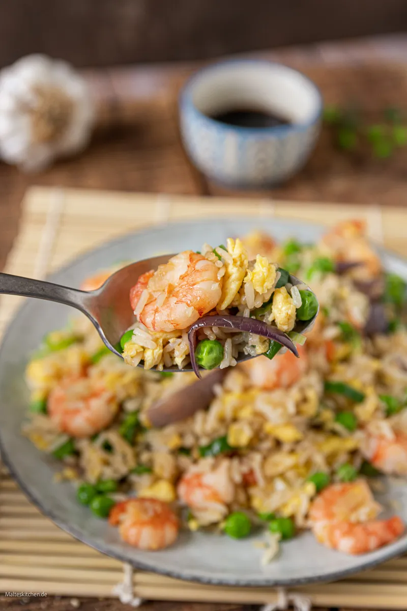 Gebratener Reis mit Garnelen, Gemüse und Ei aus dem Wok.